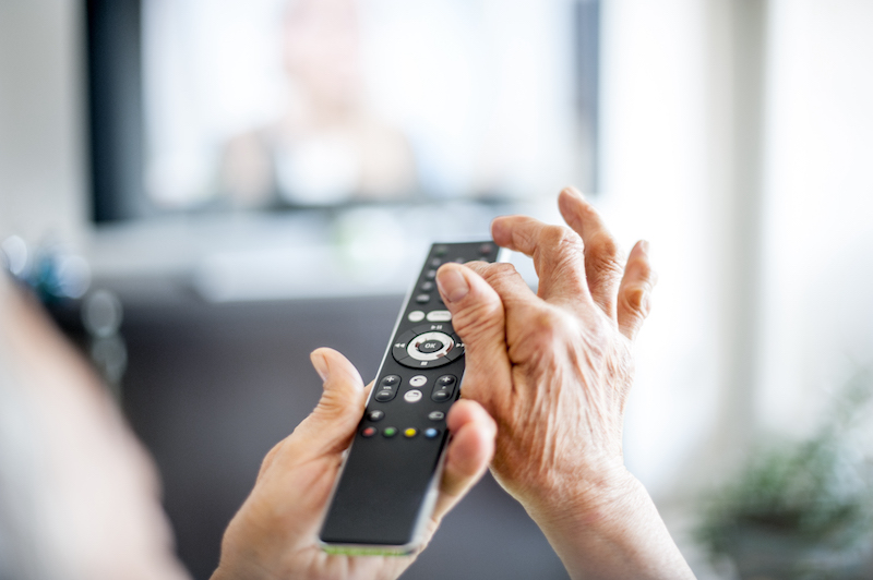 Senior woman at Golden West using remote control technology tools for older adults